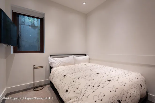 a bedroom with a bed and a mirror