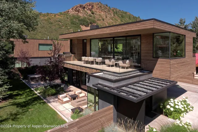 a view of a patio with table and chairs and potted plants