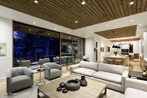 a living room with furniture and a ceiling fan