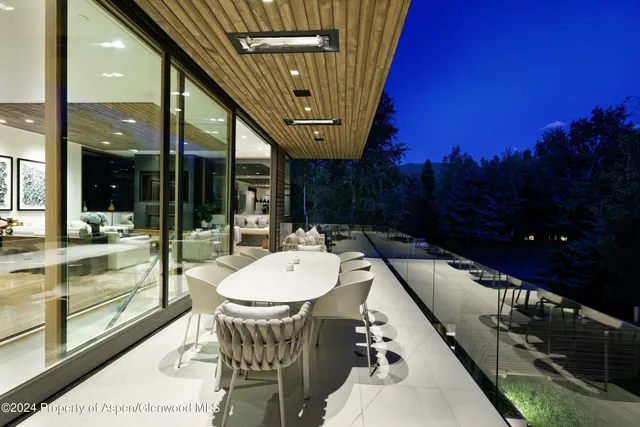 a view of a swimming pool and outdoor seating