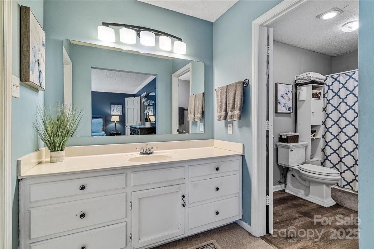5084 Mariana Court Tega Cay, SC 29708 - Photo 18 of 33 a bathroom with a double vanity sink toilet and shower