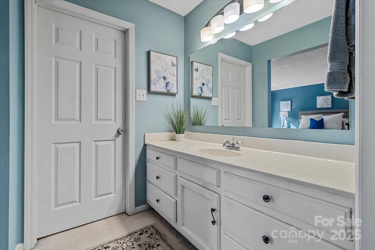 5084 Mariana Court Tega Cay, SC 29708 - Photo 19 of 33 a bathroom with a double vanity sink and mirror