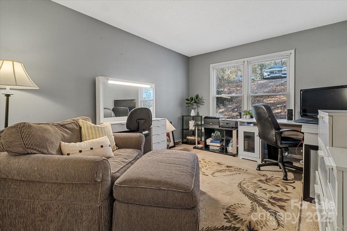 5084 Mariana Court Tega Cay, SC 29708 - Photo 21 of 33 a living room with furniture a lamp and a large window