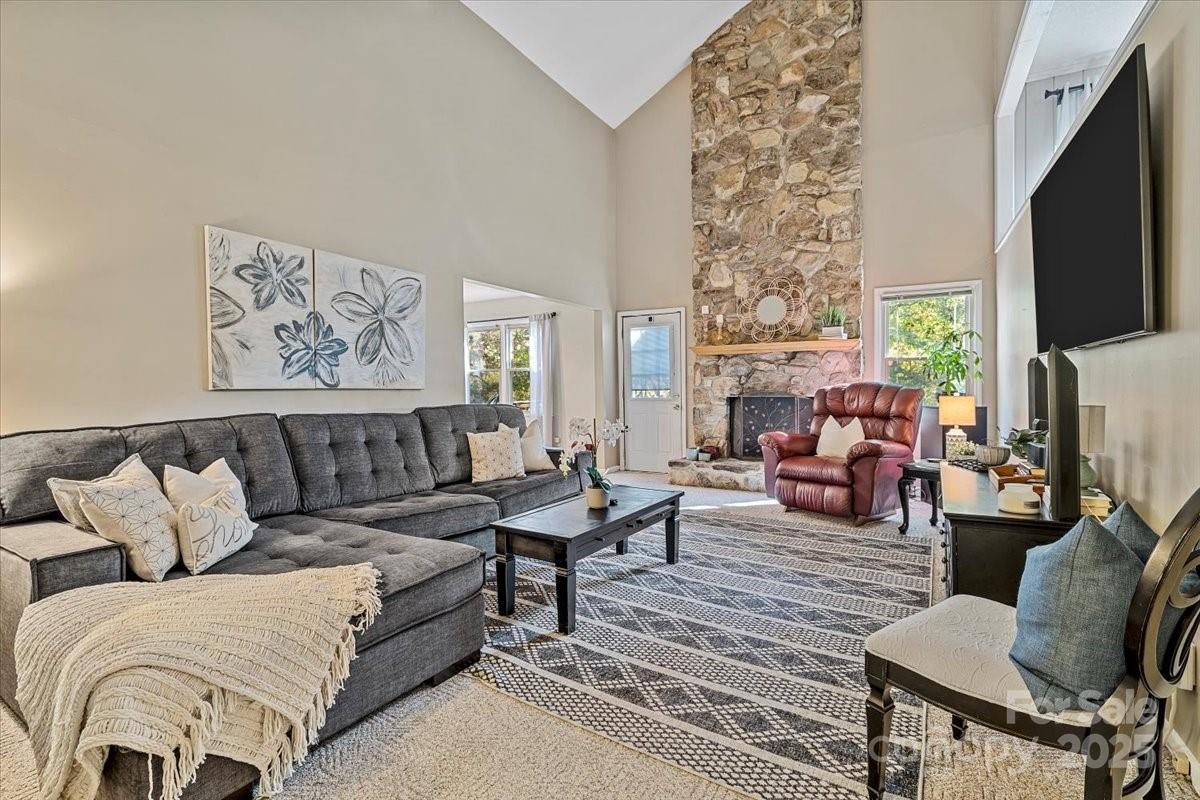 5084 Mariana Court Tega Cay, SC 29708 - Photo 5 of 33 a living room with furniture a flat screen tv and a fireplace