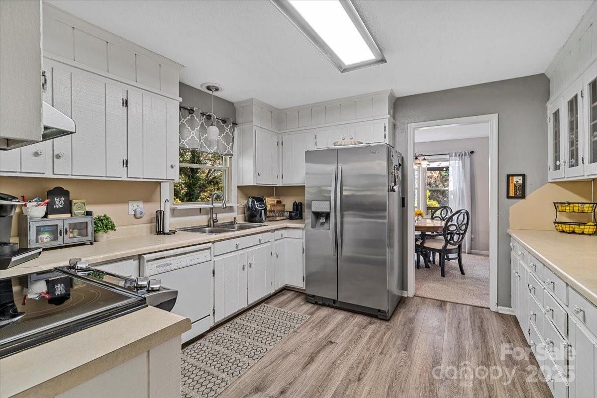5084 Mariana Court Tega Cay, SC 29708 - Photo 10 of 33 a kitchen with stainless steel appliances a refrigerator sink and cabinets
