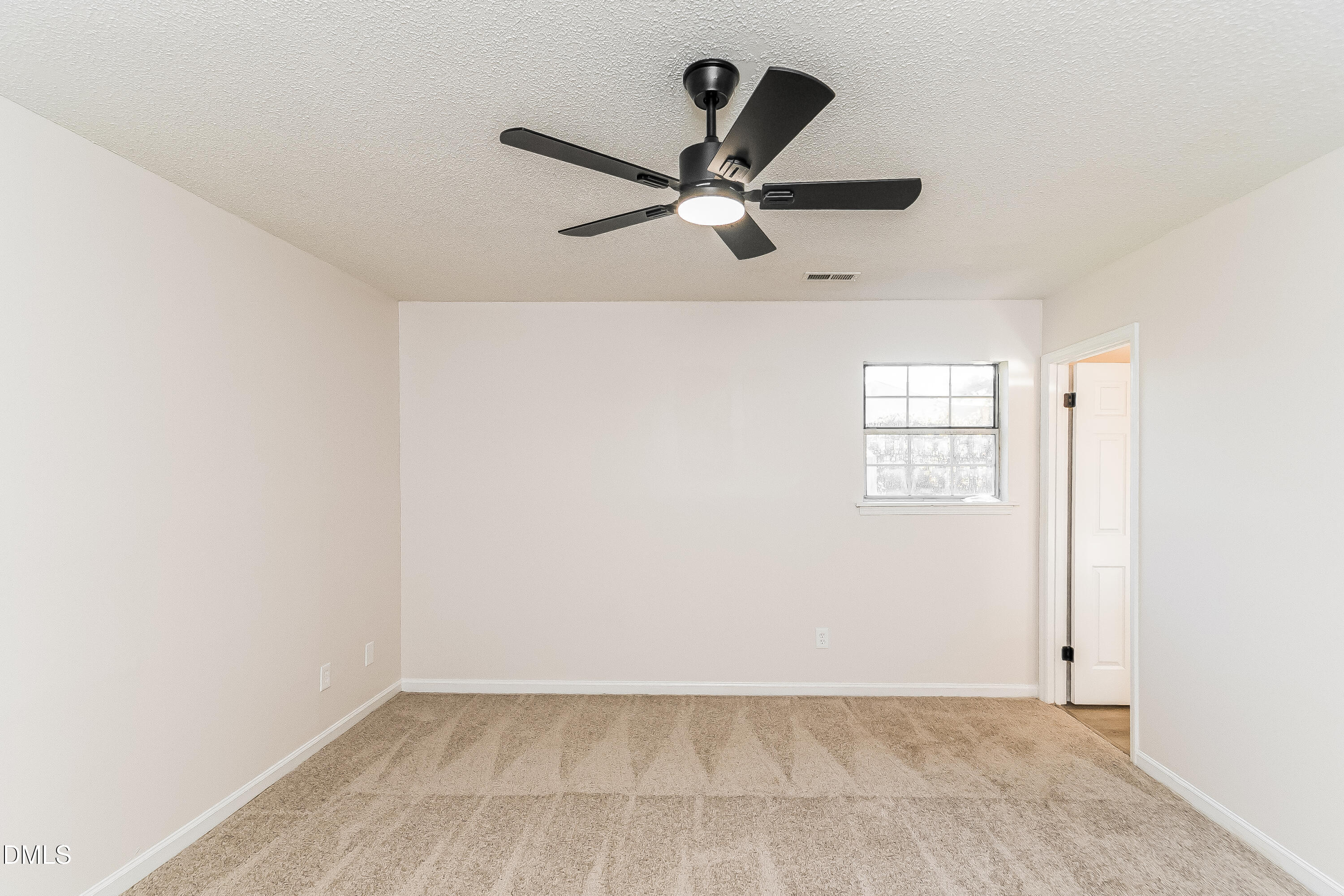 418 Craven Street Durham, NC 27704 - Photo 5 of 14 an empty room with windows and fan