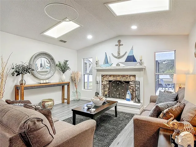 a living room with furniture a fireplace and a table