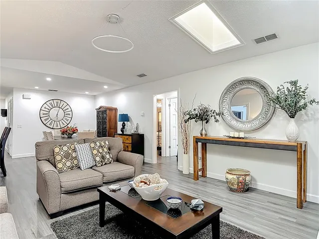 a living room with furniture and a mirror