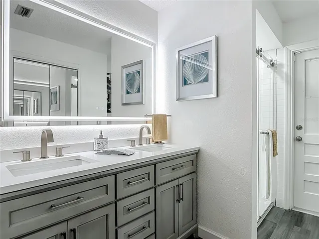 a bathroom with a double vanity sink and a mirror
