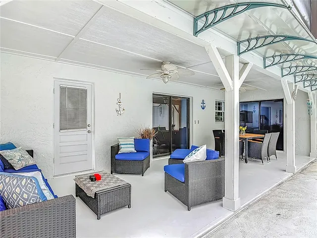 a living room with furniture a rug and white walls