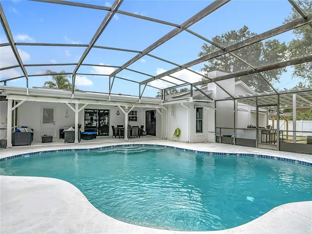 a view of a swimming pool with a yard