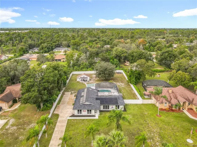 a view of a swimming pool with a yard