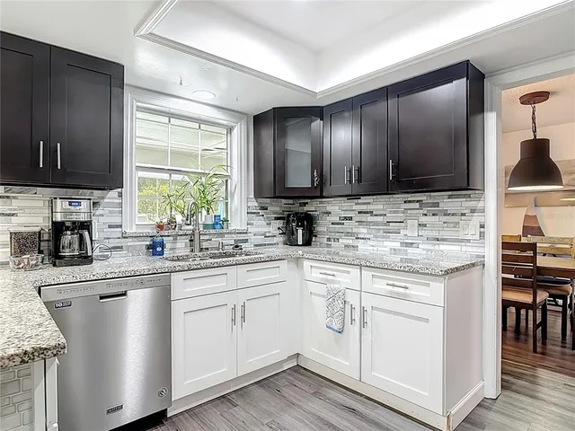 a kitchen with appliances cabinets and a sink