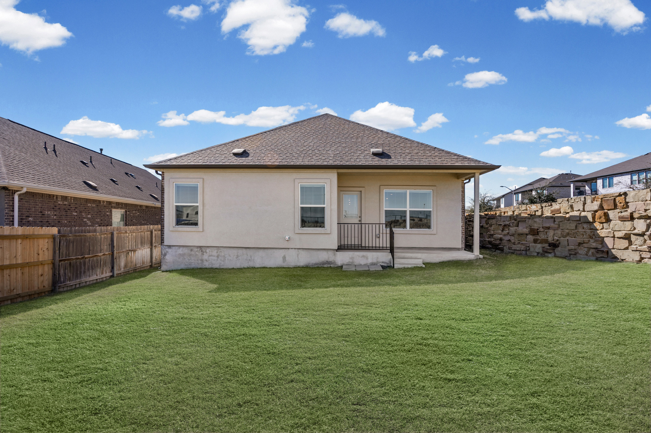 1609 Woolsey Way Leander, TX 78641 - Photo 25 of 29 Back of house with a patio, a fenced backyard, and a shingled roof