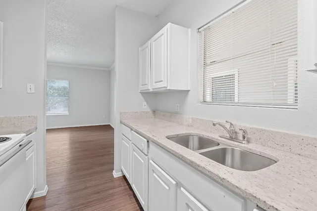 a spacious bedroom with a bed and a painting on the wall