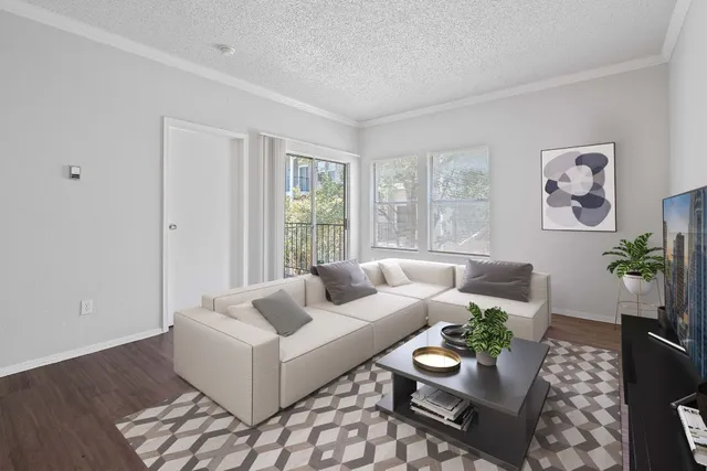 an empty room with wooden floor & windows and bathroom