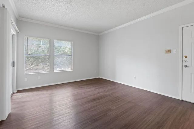 a kitchen with stainless steel appliances granite countertop a sink stove a refrigerator and white cabinets