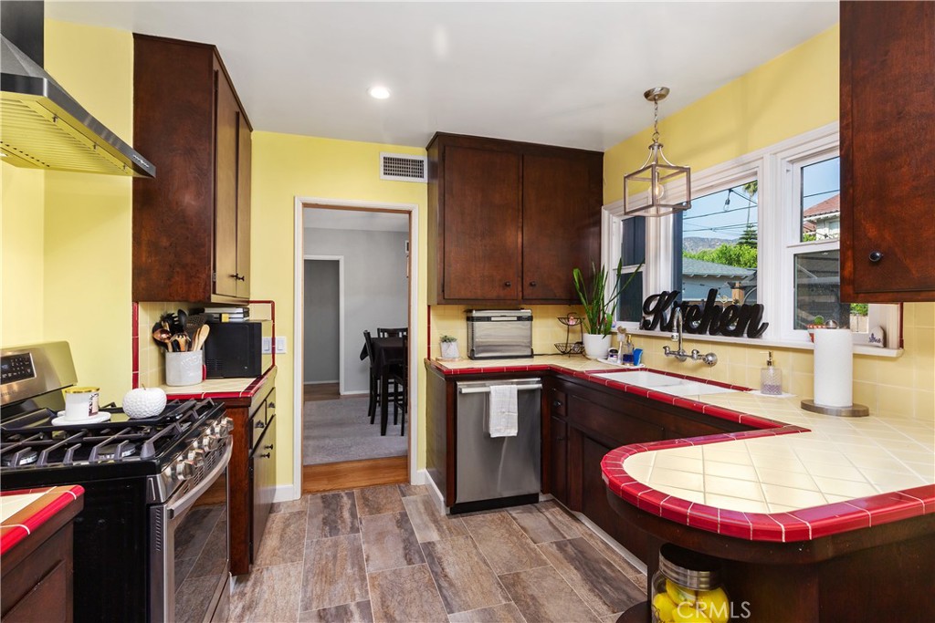 206 Melrose Avenue Monrovia, CA 91016 - Photo 16 of 35 a kitchen with stainless steel appliances granite countertop a stove and refrigerator