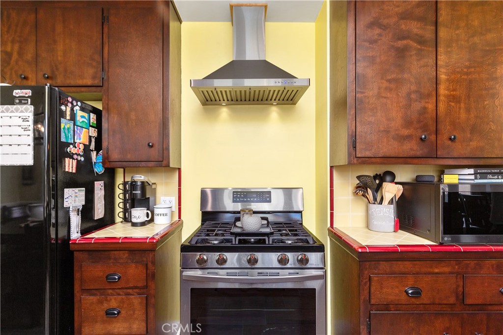 206 Melrose Avenue Monrovia, CA 91016 - Photo 20 of 35 a kitchen with stainless steel appliances granite countertop a stove and a microwave