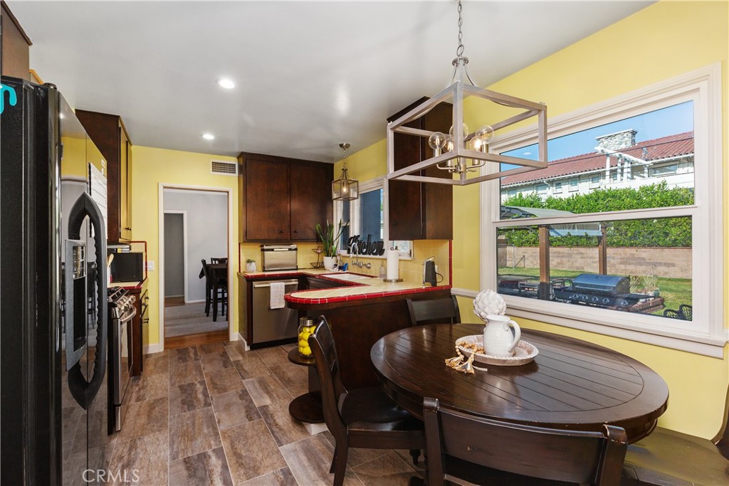 206 Melrose Avenue Monrovia, CA 91016 - Photo 21 of 35 a dining room with furniture a floor to ceiling window and wooden floor