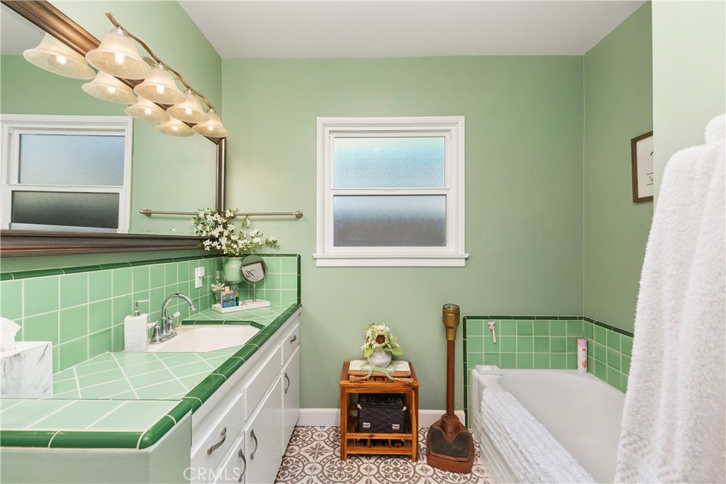 206 Melrose Avenue Monrovia, CA 91016 - Photo 25 of 35 a bathroom with a granite countertop sink and a mirror