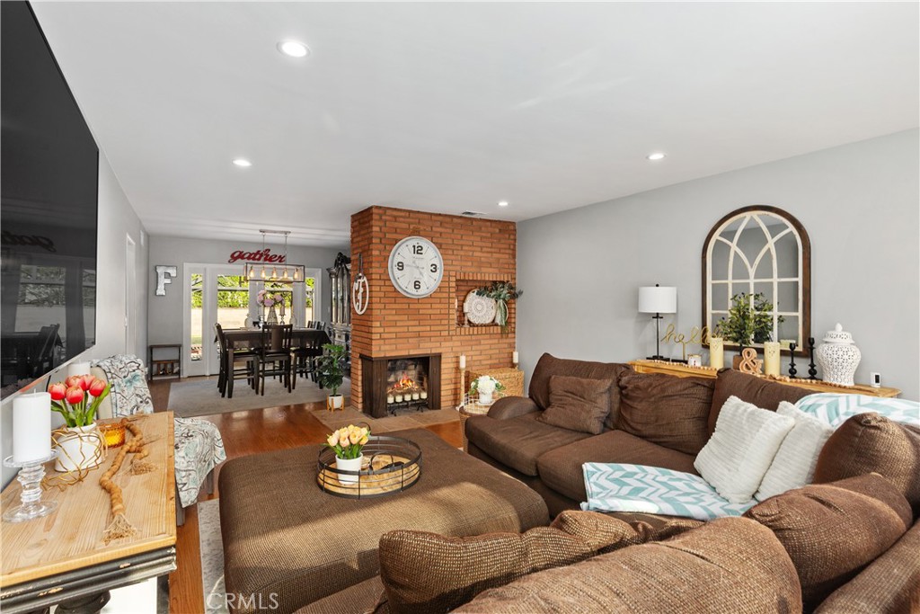 206 Melrose Avenue Monrovia, CA 91016 - Photo 10 of 35 a living room with furniture a fireplace and a flat screen tv