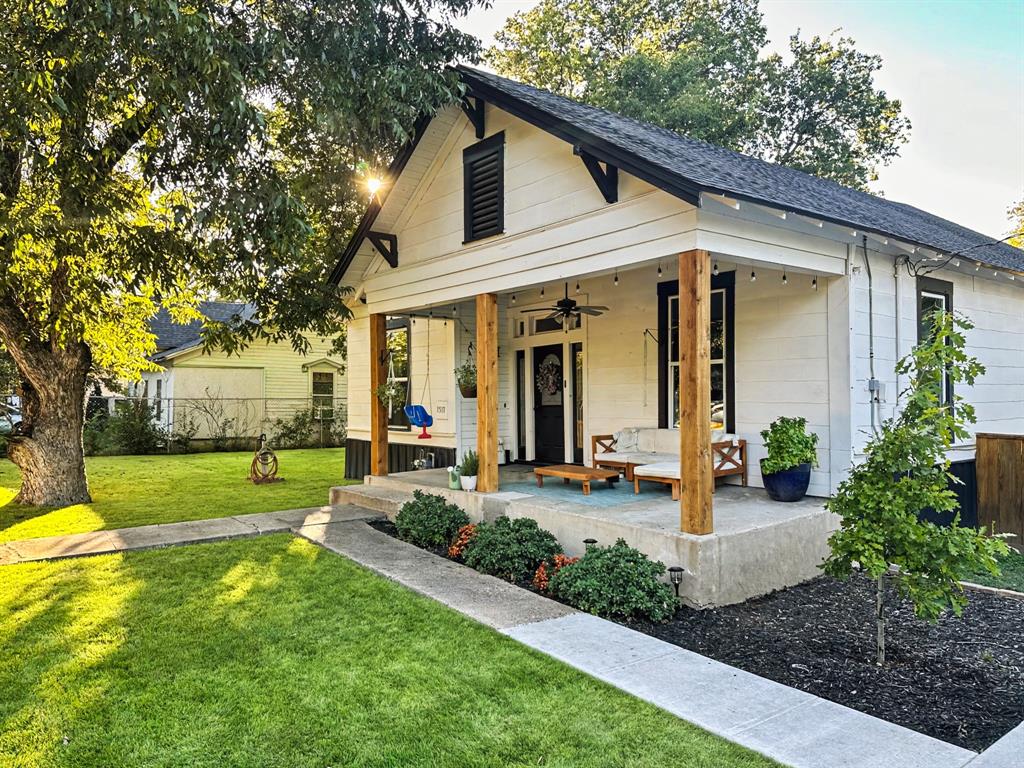 a front view of a house with garden and porch