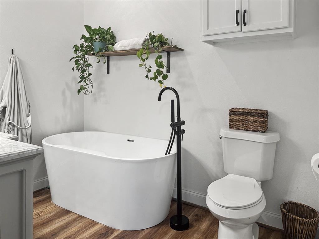 1517 Cumberland Avenue Waco, TX 76708 - Photo 16 of 30 a white bath tub sitting next to a toilet