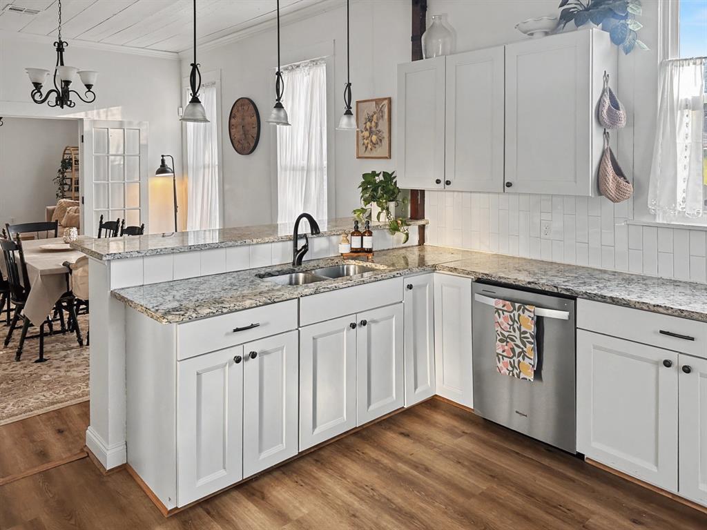1517 Cumberland Avenue Waco, TX 76708 - Photo 10 of 30 a kitchen with granite countertop white cabinets and a sink