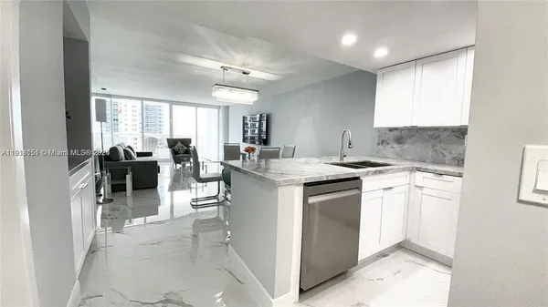 a kitchen with sink cabinets and dining table