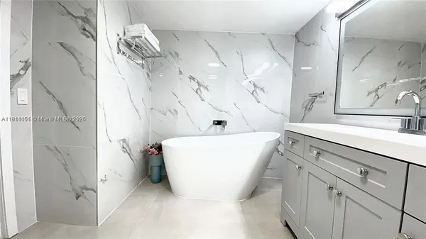 a bathroom with a bathtub and shower