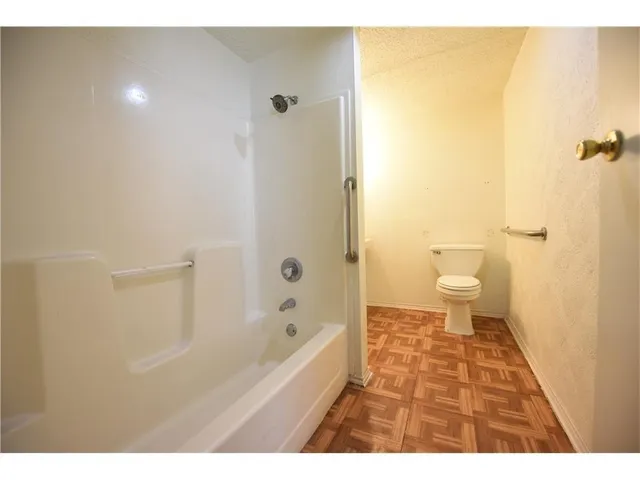 a bathroom with a bathtub and a toilet