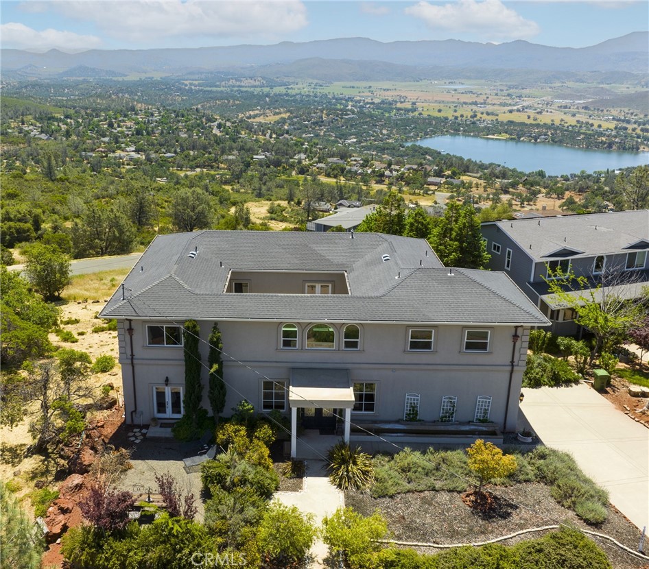 an aerial view of a house with a yard lake view and mountain view