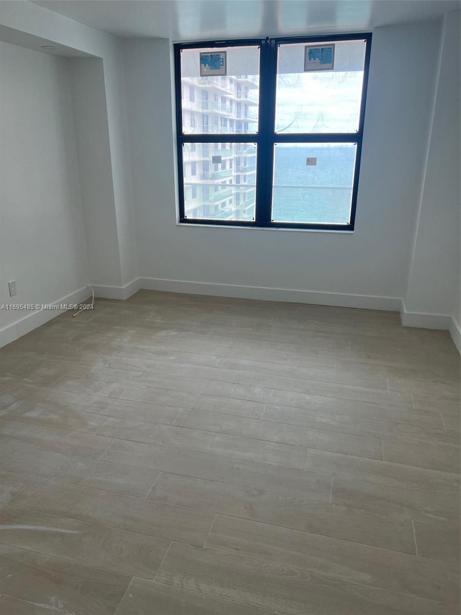 9801 Collins Avenue, Unit 15P Bal Harbour, FL 33154 - Photo 6 of 12 an empty room with a window