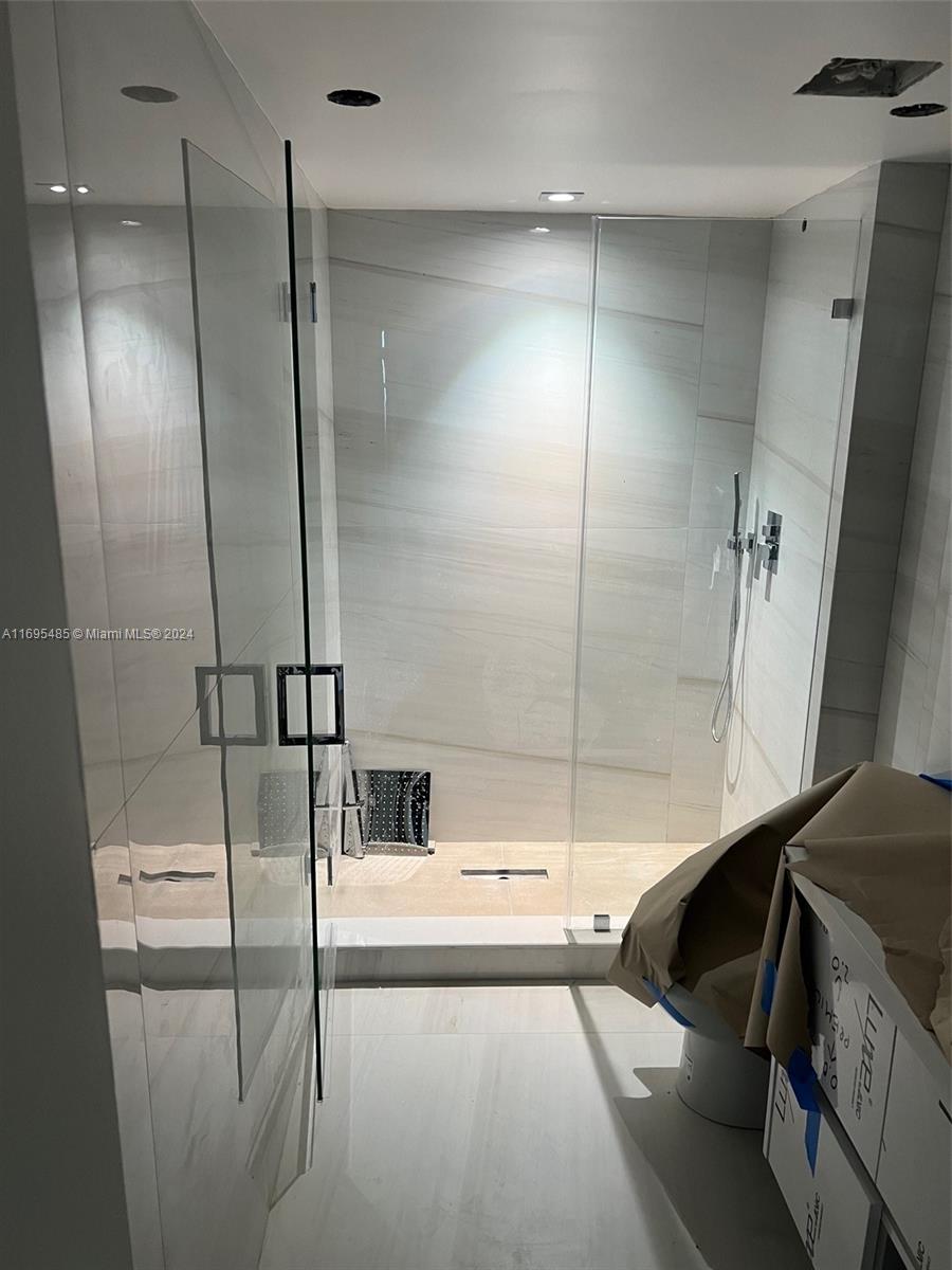 9801 Collins Avenue, Unit 15P Bal Harbour, FL 33154 - Photo 8 of 12 a bathroom with a bathtub and a shower