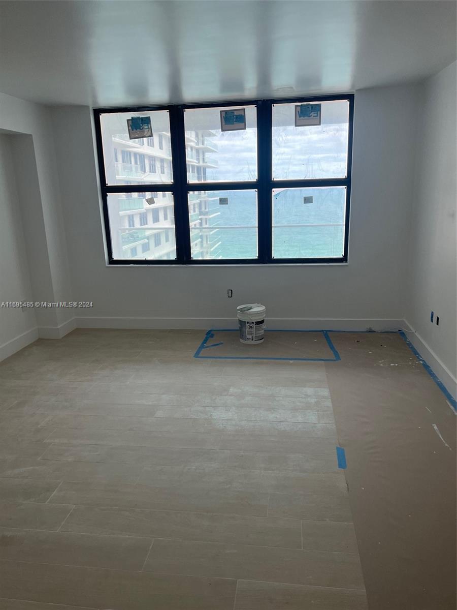 9801 Collins Avenue, Unit 15P Bal Harbour, FL 33154 - Photo 10 of 12 an empty room with windows