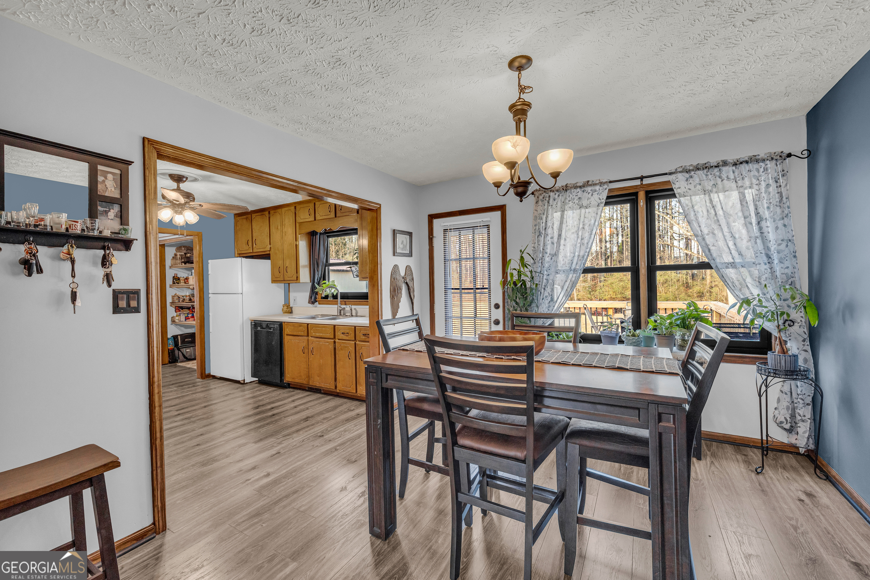 233 Kennedy Sells Road Northwest Auburn, GA 30011 - Photo 16 of 52 a view of a dining room with furniture wooden floor and chandelier