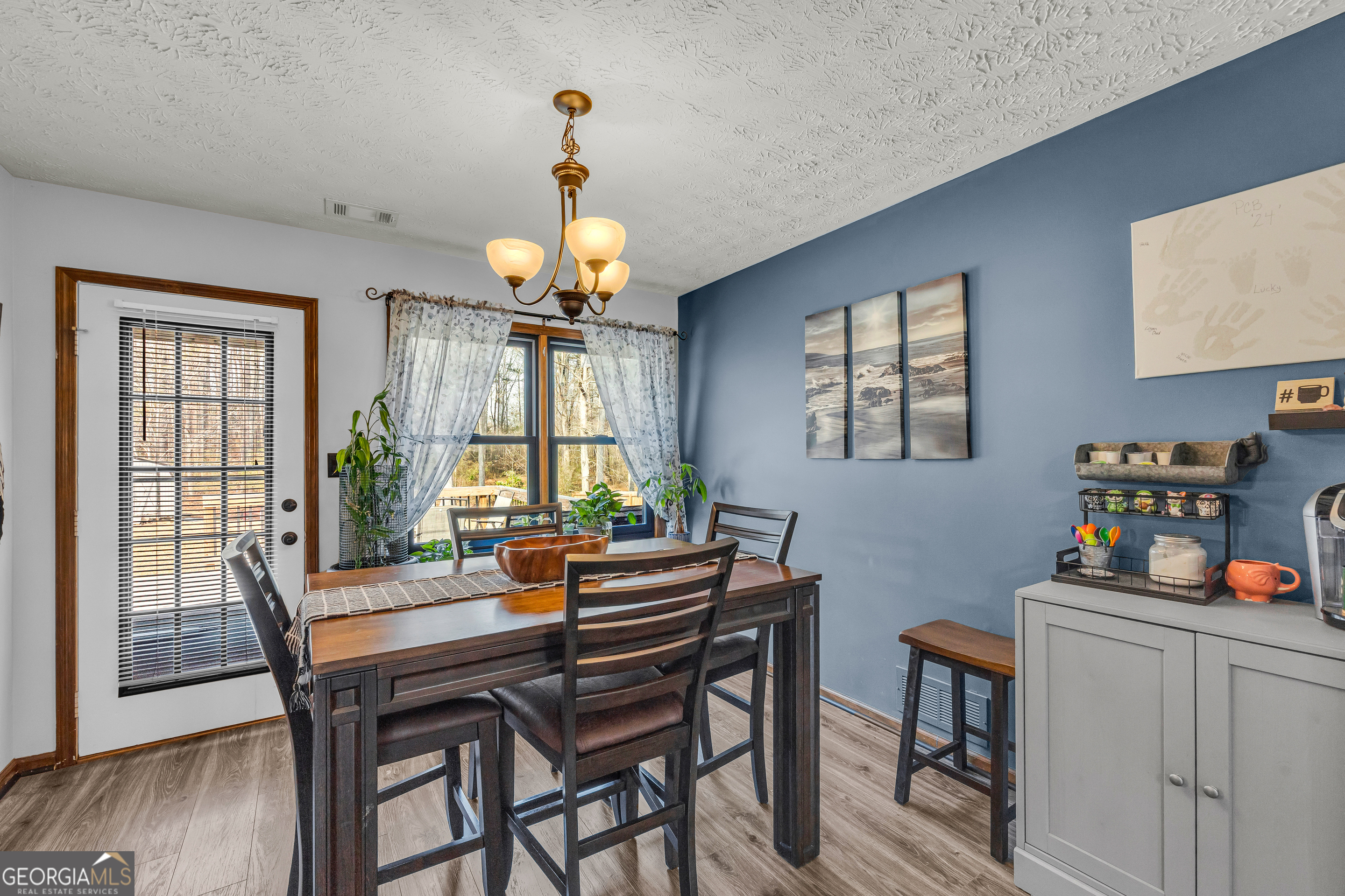 233 Kennedy Sells Road Northwest Auburn, GA 30011 - Photo 17 of 52 a view of a dining room with furniture a chandelier and wooden floor