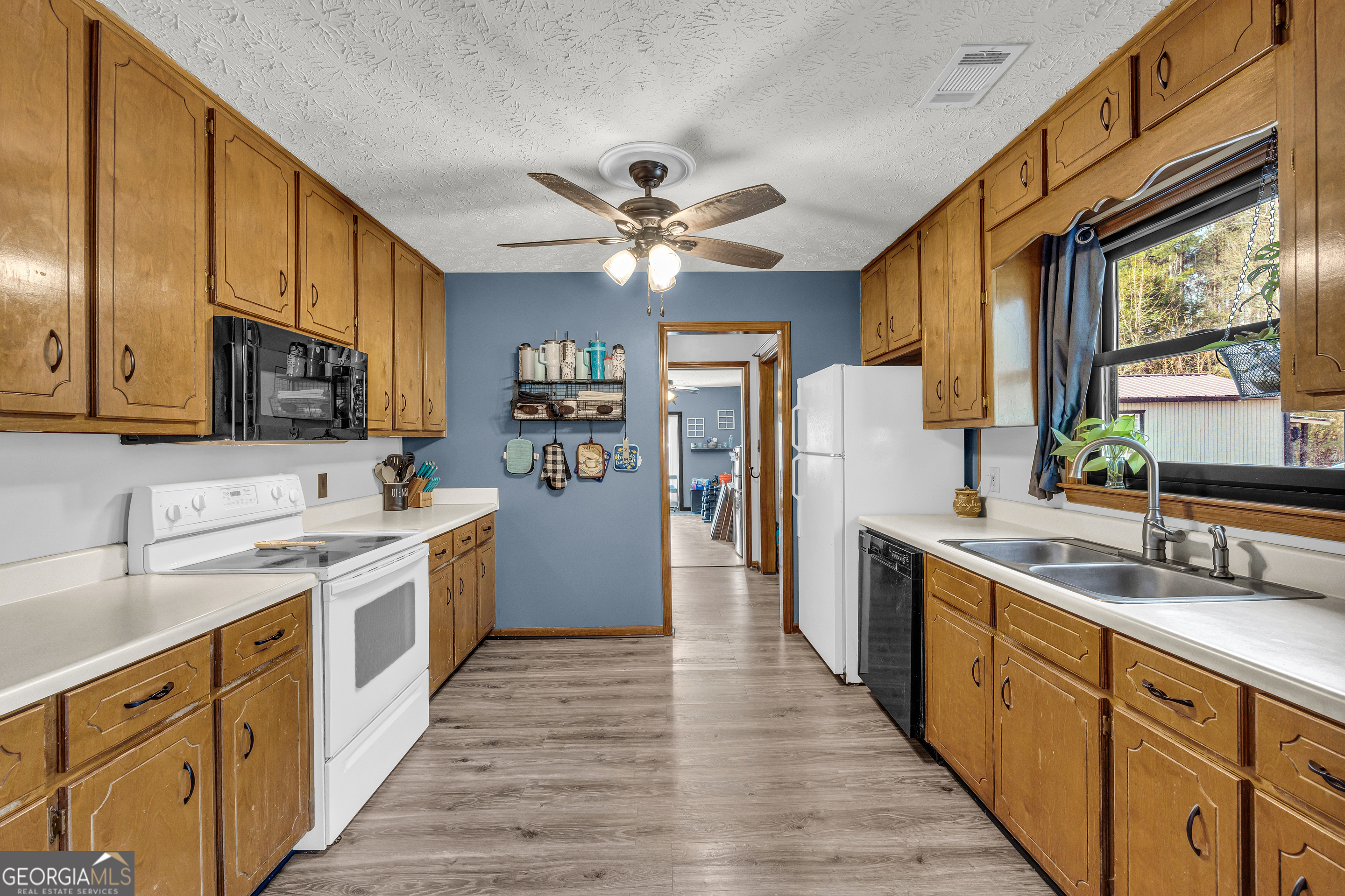 233 Kennedy Sells Road Northwest Auburn, GA 30011 - Photo 20 of 52 a kitchen with a sink stove cabinets and refrigerator