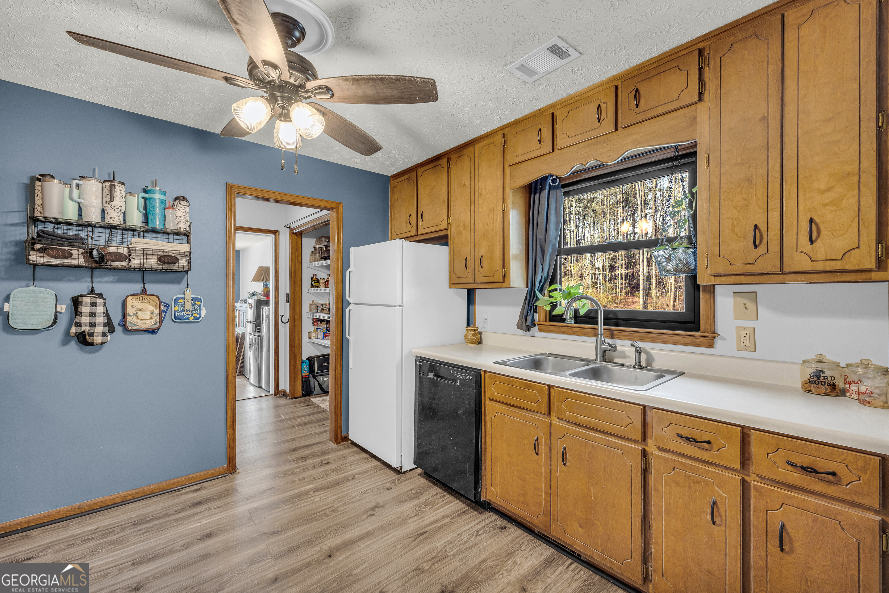 233 Kennedy Sells Road Northwest Auburn, GA 30011 - Photo 21 of 52 a kitchen with refrigerator cabinets and a sink