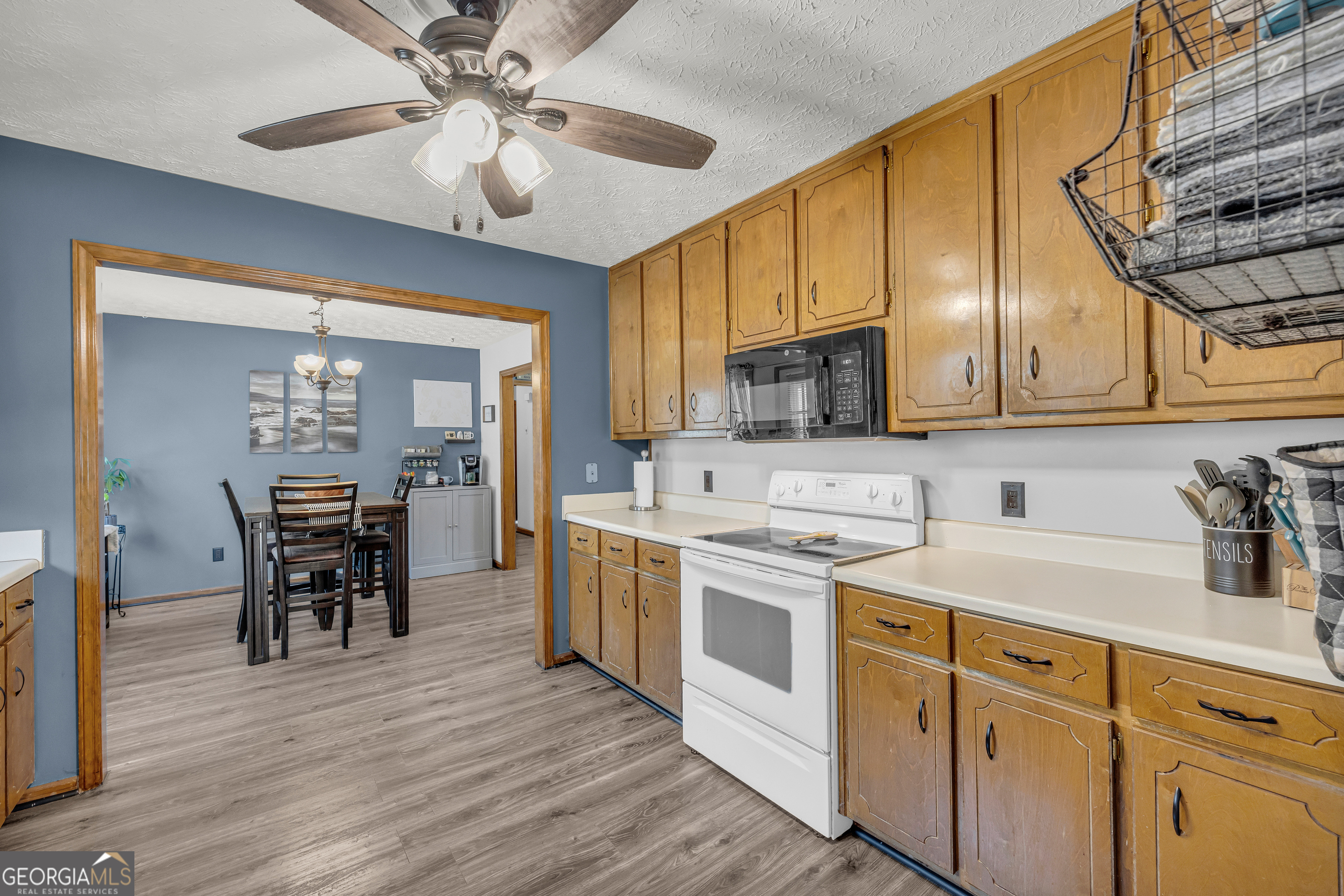 233 Kennedy Sells Road Northwest Auburn, GA 30011 - Photo 22 of 52 a kitchen with a sink cabinets and wooden floor