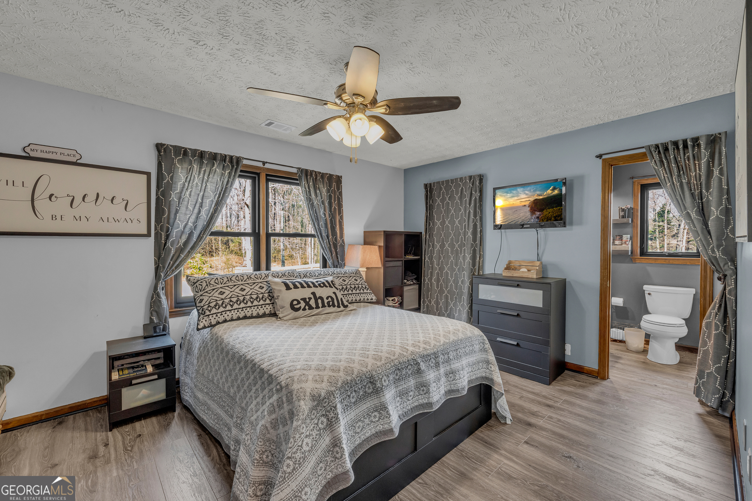 233 Kennedy Sells Road Northwest Auburn, GA 30011 - Photo 27 of 52 a bedroom with a bed and a chandelier