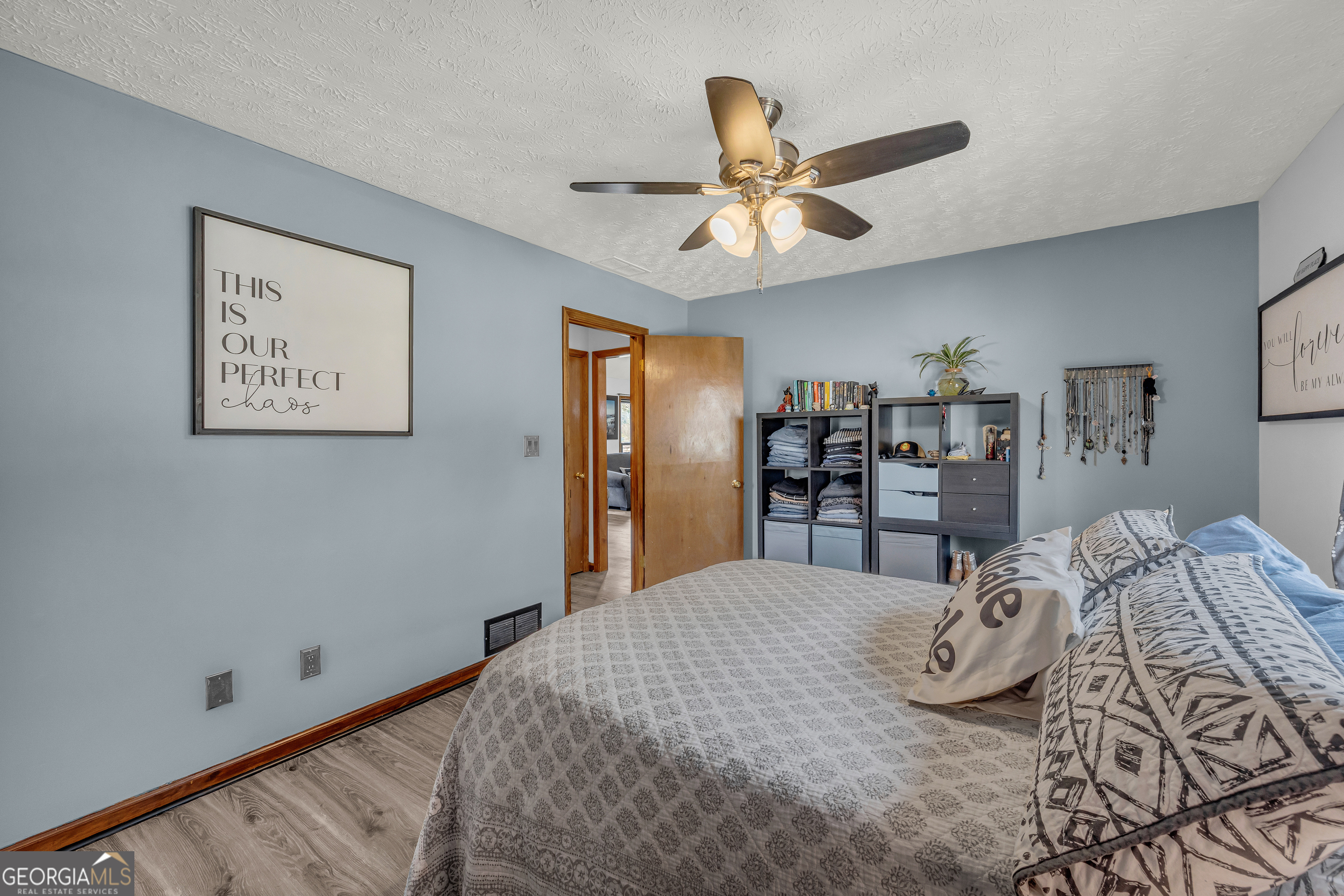 233 Kennedy Sells Road Northwest Auburn, GA 30011 - Photo 29 of 52 a bedroom with a large bed and a chandelier