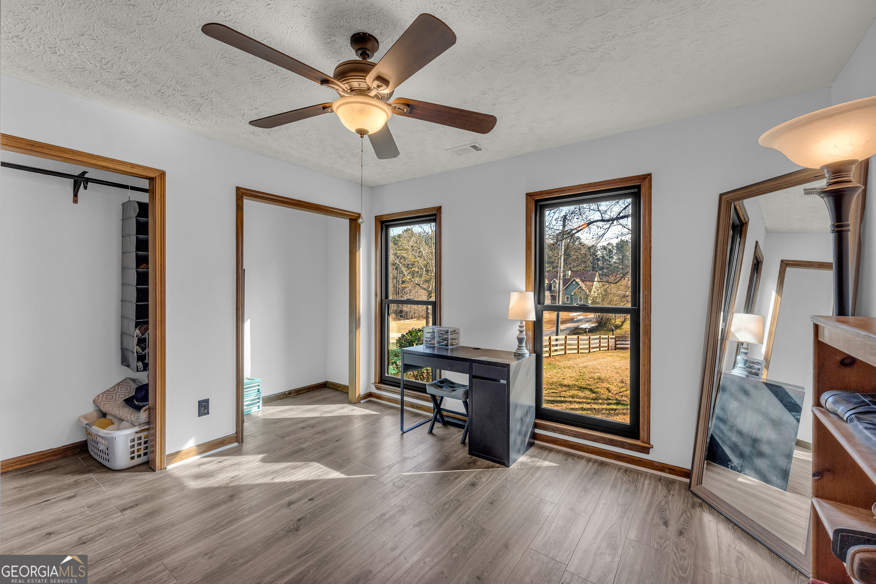 233 Kennedy Sells Road Northwest Auburn, GA 30011 - Photo 32 of 52 a view of an empty room with window wooden floor and a ceiling fan