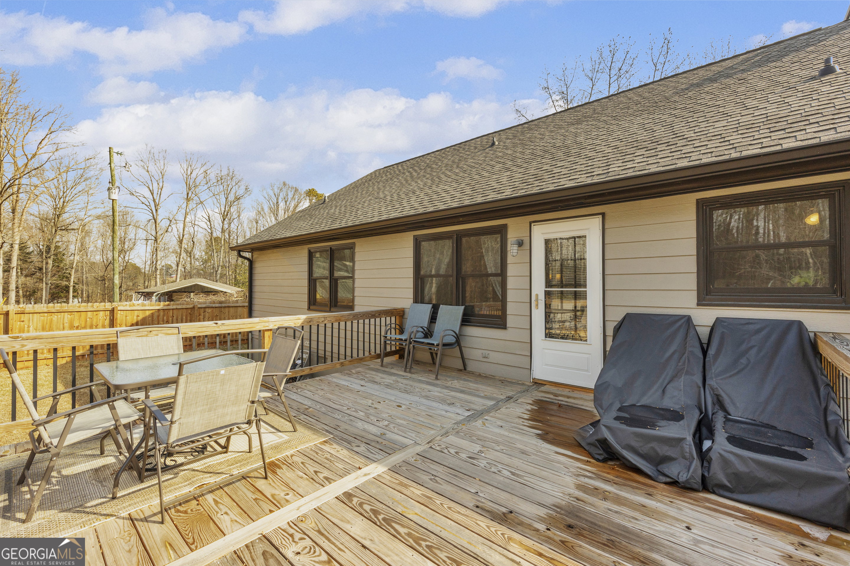 233 Kennedy Sells Road Northwest Auburn, GA 30011 - Photo 39 of 52 a roof deck with table and chairs and wooden floor