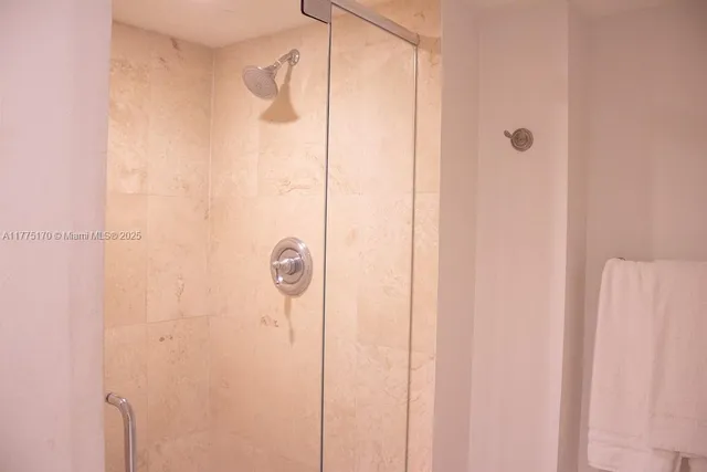 a bathroom with a glass shower door