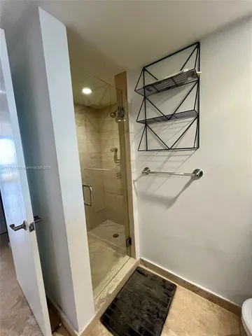 a bathroom with a shower and a toilet