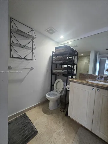 a large bed sitting in a bedroom next to a window