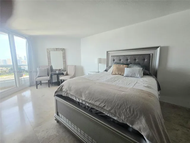 a dining room with furniture and a floor to ceiling window