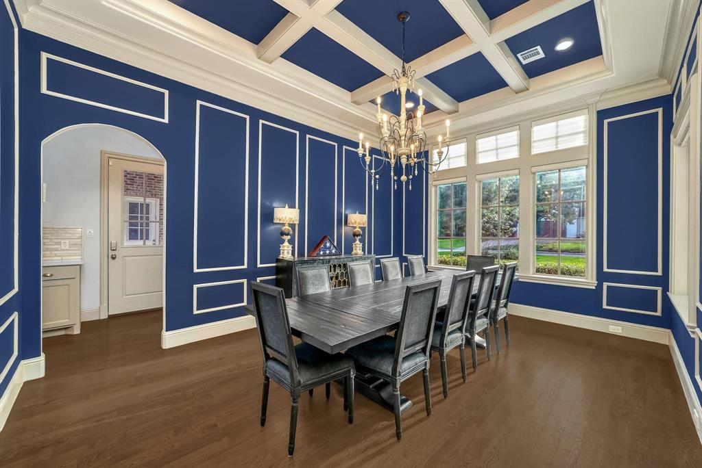 12114 Prestonridge Road Dallas, TX 75230 - Photo 14 of 40 Formal dining room featuring extensive wainscoting and crown molding on blue walls